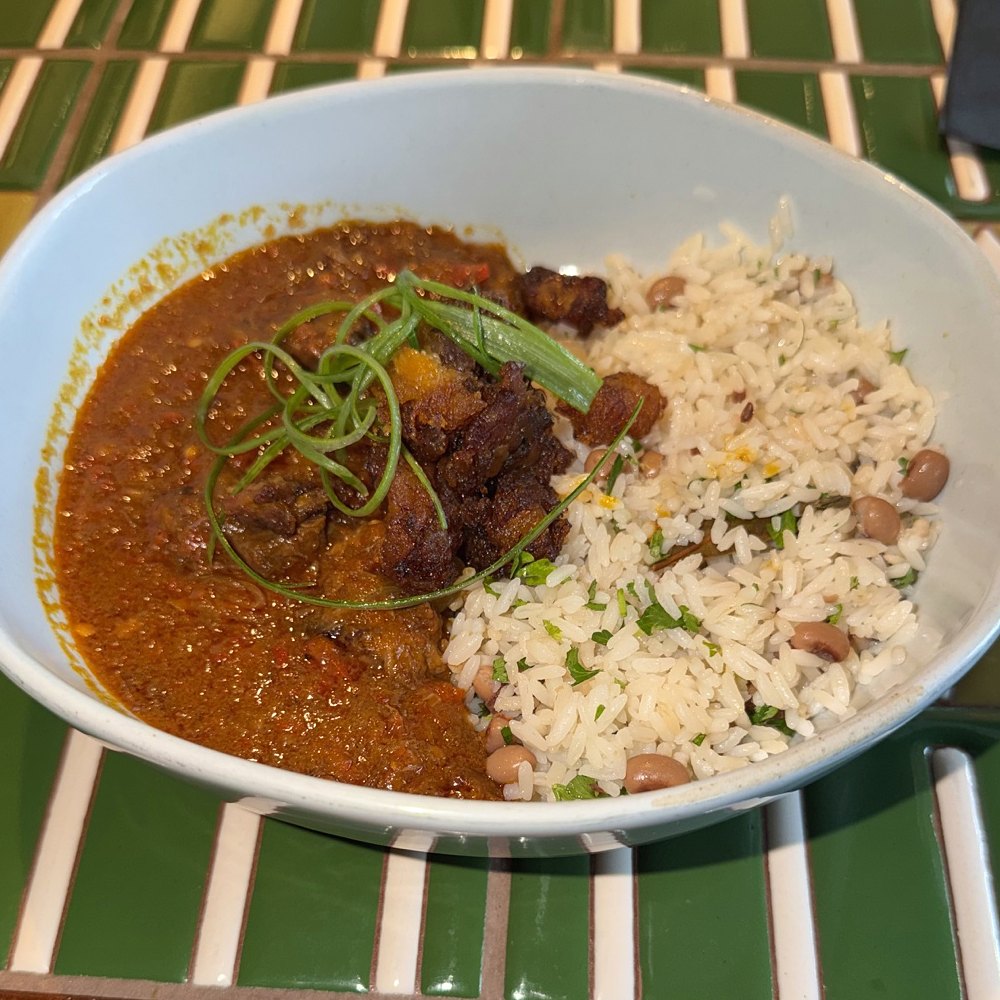 A ChòpnBlọk plate: stew, rice and beans